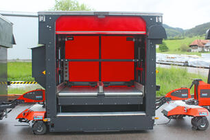 Outdoor AGV: Factory Train autonomous outdoor tugger train with materials handling load carrier